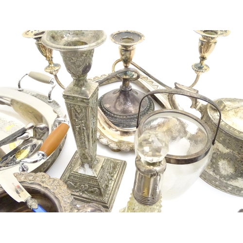 433A - A large equanimity of assorted silver plated wares to include candlesticks, flatware, serving dishes... 