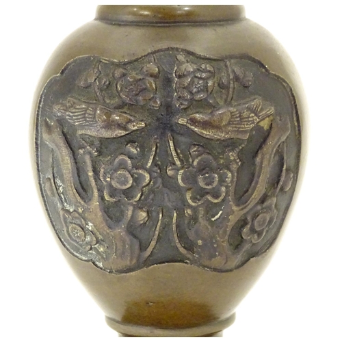 847 - An Oriental bronze vase of baluster form with a stepped base and neck, the body with cast vignettes ... 