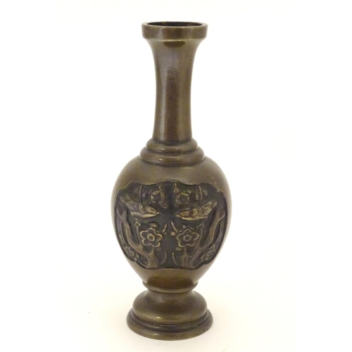 847 - An Oriental bronze vase of baluster form with a stepped base and neck, the body with cast vignettes ... 