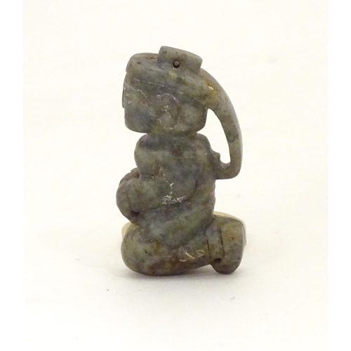 848 - Three Chinese stone carvings / amulets / pendants, comprising a carved kneeling figure, a stylised f... 