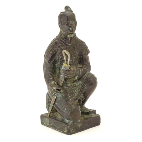 849 - A 20thC model of a kneeling samurai. Approx. 5 1/4