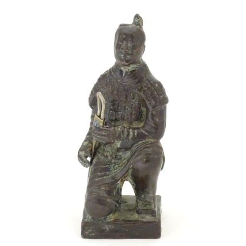 849 - A 20thC model of a kneeling samurai. Approx. 5 1/4