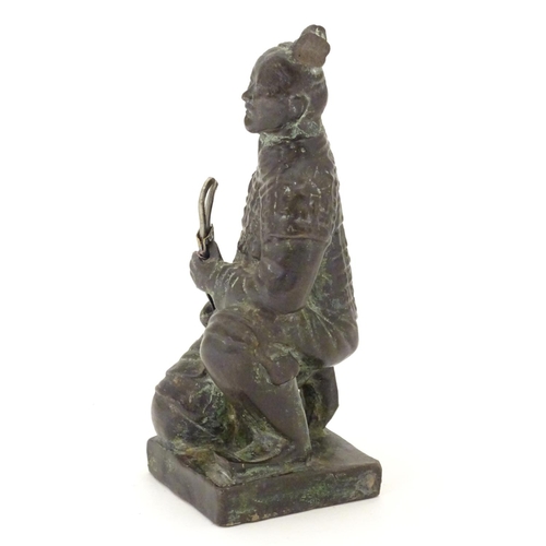 849 - A 20thC model of a kneeling samurai. Approx. 5 1/4