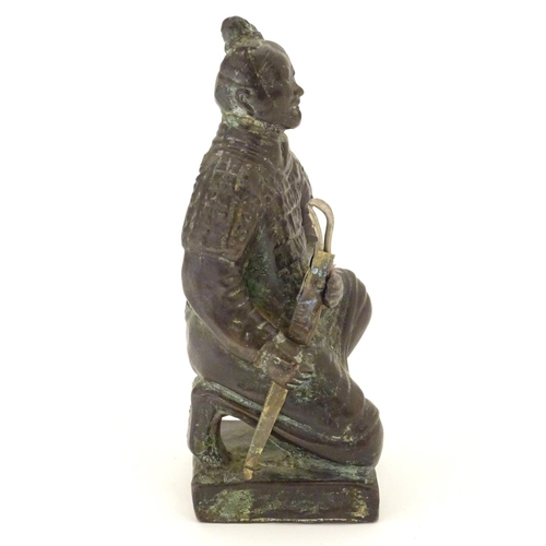 849 - A 20thC model of a kneeling samurai. Approx. 5 1/4