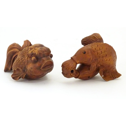 850 - A carved netsuke modelled as two fish, together with a model of a fish. Largest approx. 2