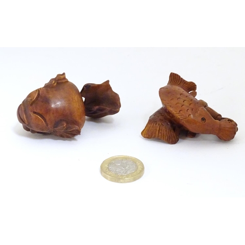 850 - A carved netsuke modelled as two fish, together with a model of a fish. Largest approx. 2