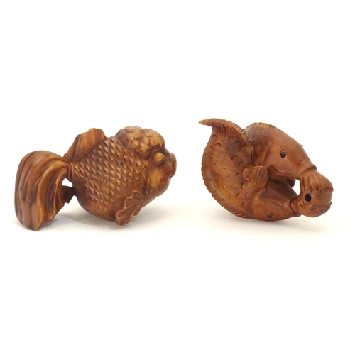 850 - A carved netsuke modelled as two fish, together with a model of a fish. Largest approx. 2