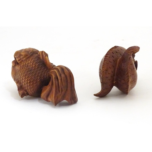 850 - A carved netsuke modelled as two fish, together with a model of a fish. Largest approx. 2