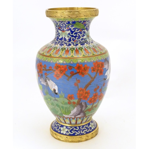 854 - A 20thC Chinese cloisonne vase of baluster form, decorated with crane birds, flowers to include peon... 