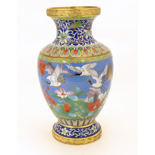 854 - A 20thC Chinese cloisonne vase of baluster form, decorated with crane birds, flowers to include peon... 