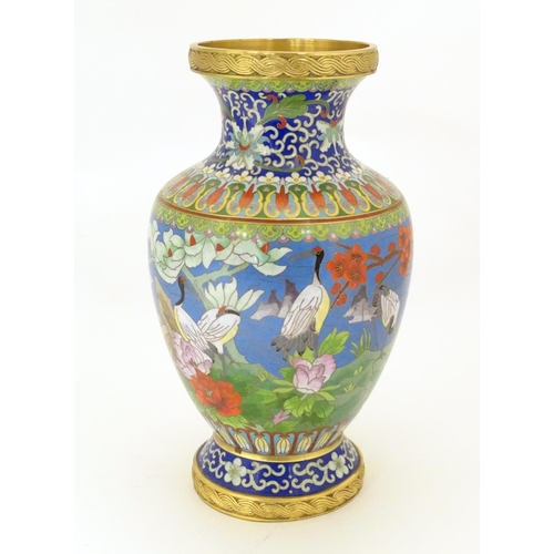 854 - A 20thC Chinese cloisonne vase of baluster form, decorated with crane birds, flowers to include peon... 