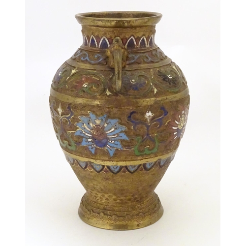 855 - A Japanese gilded brass vase of ovoid form with twin handles and cloisonne decoration. Approx. 9 1/2... 