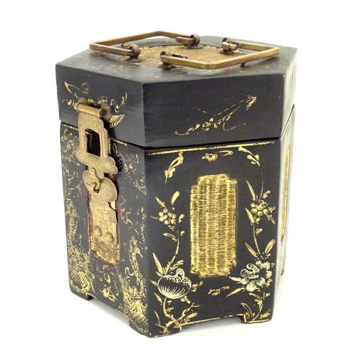 857 - A Chinese lacquer tea caddy of hexagonal form with a hinged lid, scrolling floral and foliate detail... 