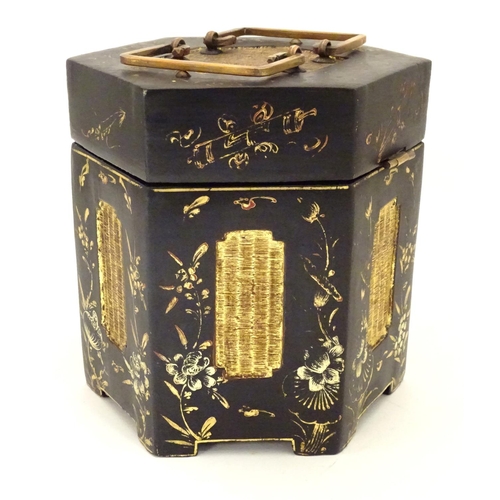 857 - A Chinese lacquer tea caddy of hexagonal form with a hinged lid, scrolling floral and foliate detail... 