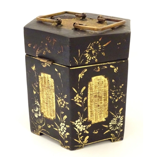 857 - A Chinese lacquer tea caddy of hexagonal form with a hinged lid, scrolling floral and foliate detail... 