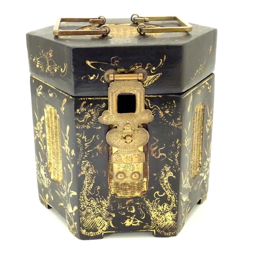 857 - A Chinese lacquer tea caddy of hexagonal form with a hinged lid, scrolling floral and foliate detail... 