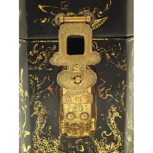 857 - A Chinese lacquer tea caddy of hexagonal form with a hinged lid, scrolling floral and foliate detail... 