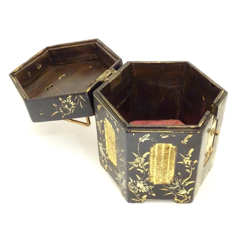 857 - A Chinese lacquer tea caddy of hexagonal form with a hinged lid, scrolling floral and foliate detail... 