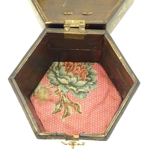 857 - A Chinese lacquer tea caddy of hexagonal form with a hinged lid, scrolling floral and foliate detail... 