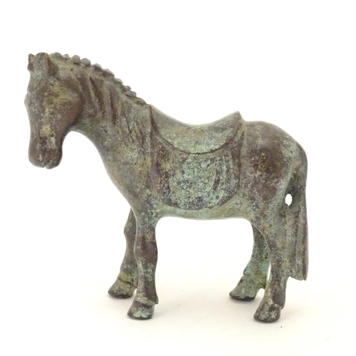 859 - An Oriental bronze model of standing horse with saddle. Approx. 4