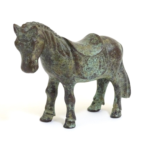 859 - An Oriental bronze model of standing horse with saddle. Approx. 4