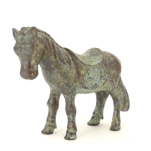 859 - An Oriental bronze model of standing horse with saddle. Approx. 4