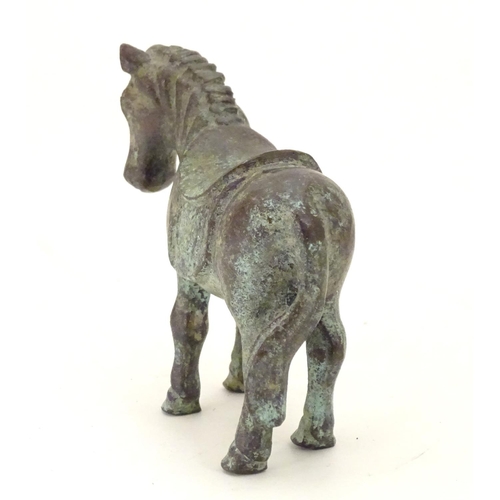 859 - An Oriental bronze model of standing horse with saddle. Approx. 4