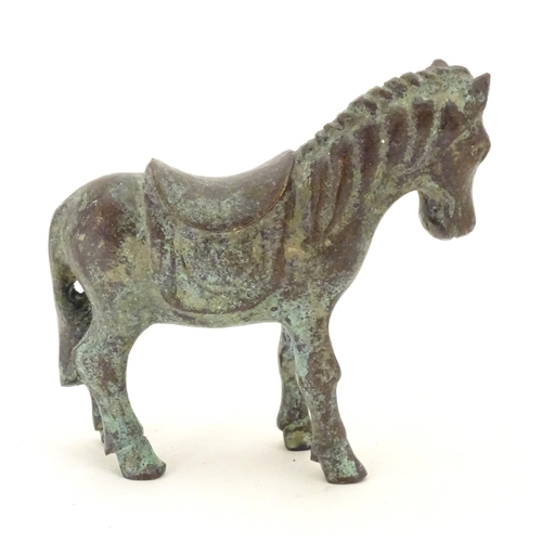 859 - An Oriental bronze model of standing horse with saddle. Approx. 4