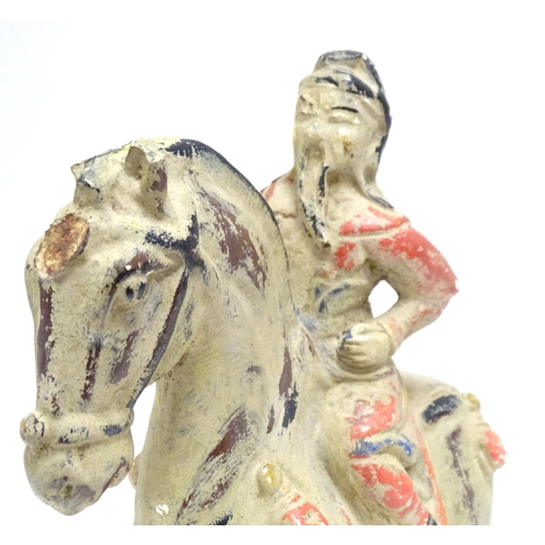 860 - A Chinese model of a figure on horseback with polychrome decoration. Approx. 9 1/2