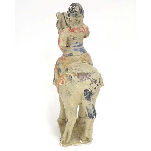 860 - A Chinese model of a figure on horseback with polychrome decoration. Approx. 9 1/2