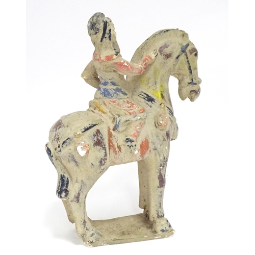 860 - A Chinese model of a figure on horseback with polychrome decoration. Approx. 9 1/2