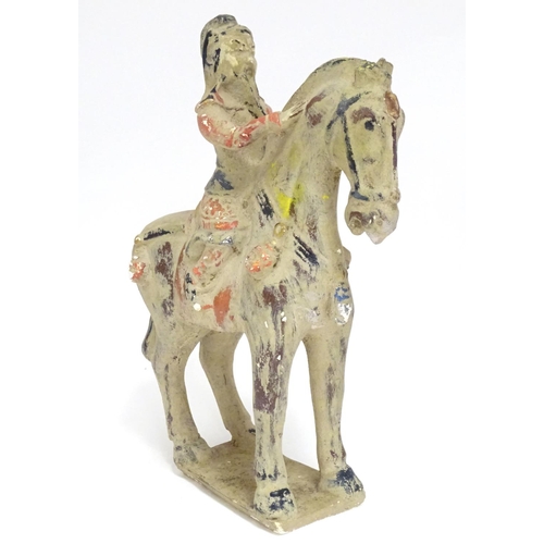 860 - A Chinese model of a figure on horseback with polychrome decoration. Approx. 9 1/2