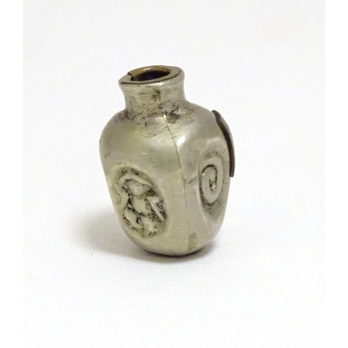 864 - A Japanese silver plate ojime bead formed as a stylised vase with impressed detail and applied brass... 