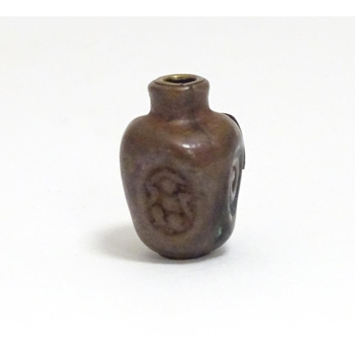 865 - A Japanese ojime bead formed as a stylised vase with impressed detail and applied brass character ma... 