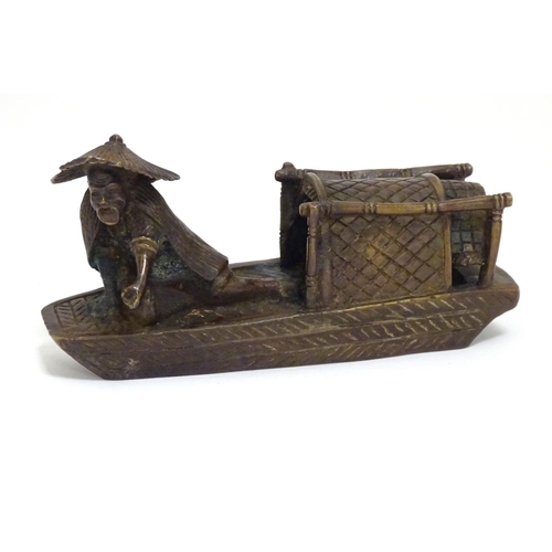 868 - An Oriental bronze model of a fishing boat with a figure fishing. Approx. 6 1/2