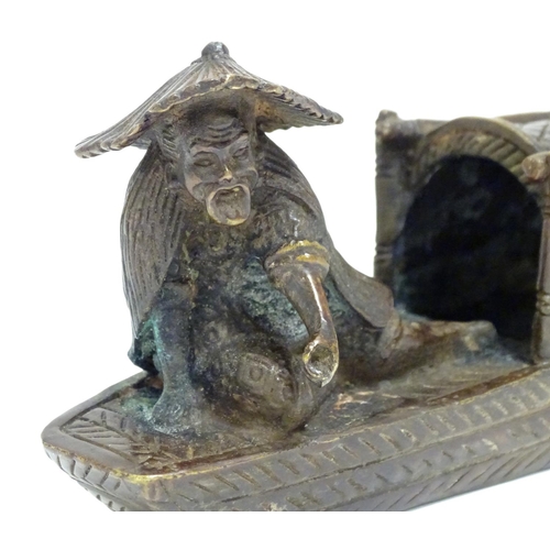 868 - An Oriental bronze model of a fishing boat with a figure fishing. Approx. 6 1/2