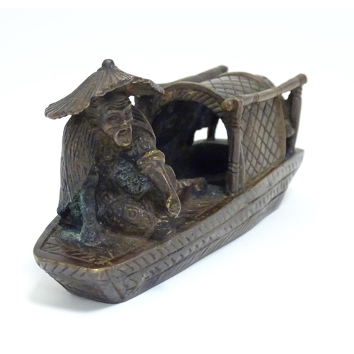 868 - An Oriental bronze model of a fishing boat with a figure fishing. Approx. 6 1/2