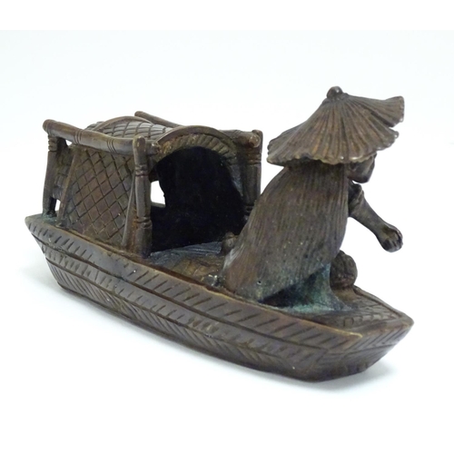 868 - An Oriental bronze model of a fishing boat with a figure fishing. Approx. 6 1/2