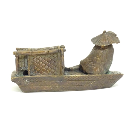 868 - An Oriental bronze model of a fishing boat with a figure fishing. Approx. 6 1/2