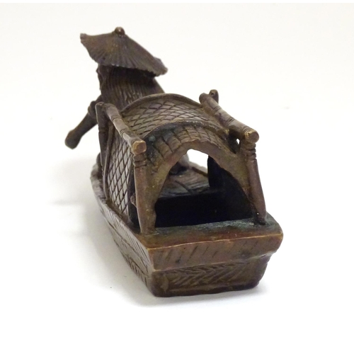 868 - An Oriental bronze model of a fishing boat with a figure fishing. Approx. 6 1/2