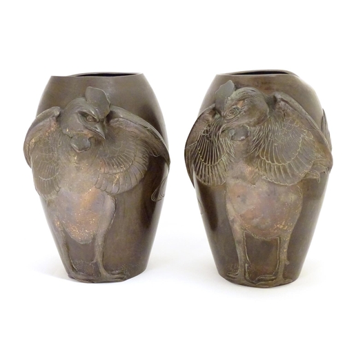 875 - A pair of late 19th / early 20thC Japanese bronze vases with relief cockerel decoration. The inner b... 