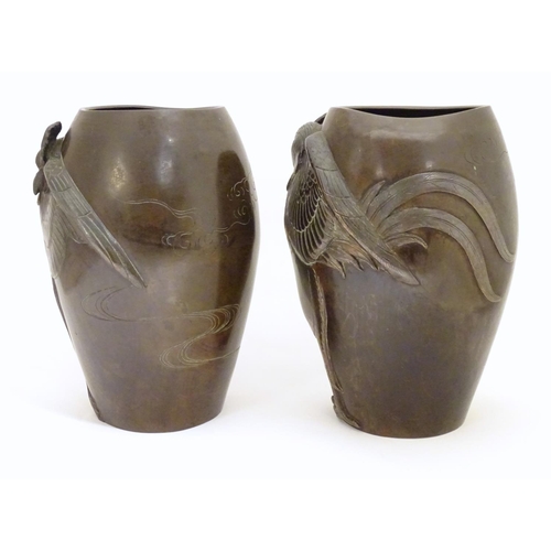 875 - A pair of late 19th / early 20thC Japanese bronze vases with relief cockerel decoration. The inner b... 