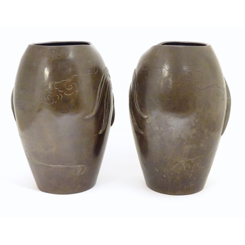 875 - A pair of late 19th / early 20thC Japanese bronze vases with relief cockerel decoration. The inner b... 