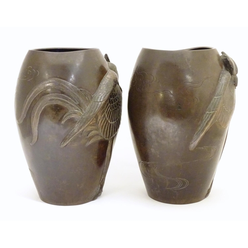 875 - A pair of late 19th / early 20thC Japanese bronze vases with relief cockerel decoration. The inner b... 