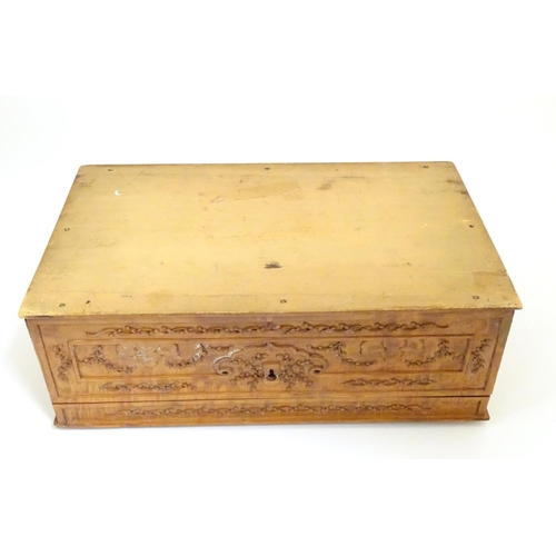 877 - A camphor wood box with carved floral and foliate detail, the lid with a carved vignette depicting a... 