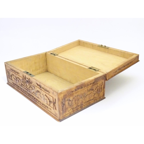 877 - A camphor wood box with carved floral and foliate detail, the lid with a carved vignette depicting a... 