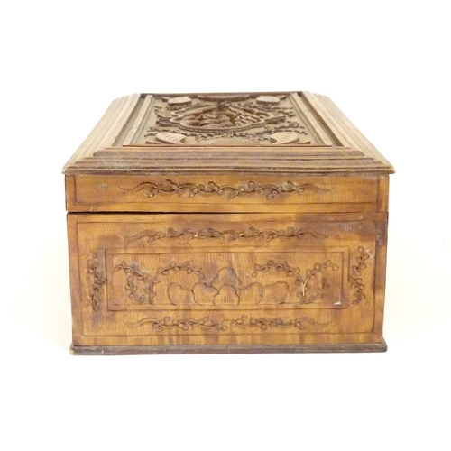 877 - A camphor wood box with carved floral and foliate detail, the lid with a carved vignette depicting a... 