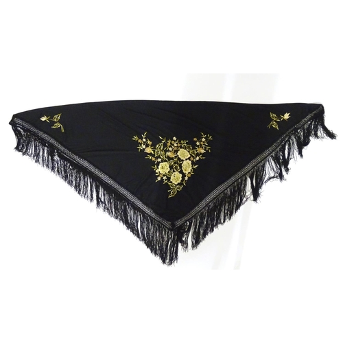 881 - A Victorian black fringed shawl with floral embroidery.