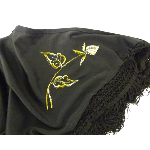 881 - A Victorian black fringed shawl with floral embroidery.