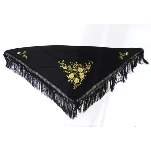 881 - A Victorian black fringed shawl with floral embroidery.